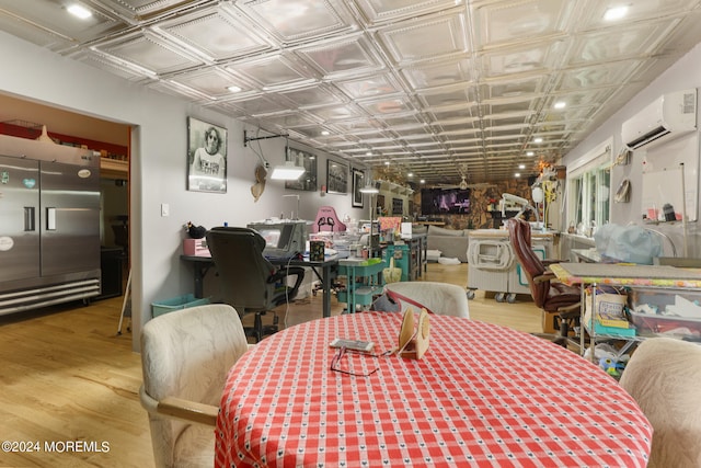 dining room with a wall mounted air conditioner and hardwood / wood-style floors