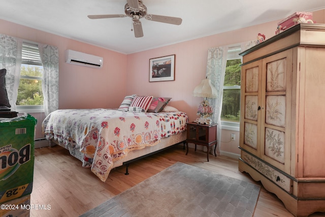 bedroom with wood-type flooring, an AC wall unit, multiple windows, and ceiling fan