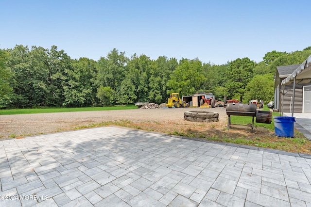 view of patio / terrace featuring an outdoor fire pit