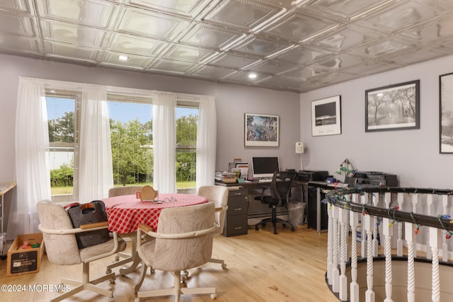 office area featuring a baseboard radiator and light hardwood / wood-style flooring