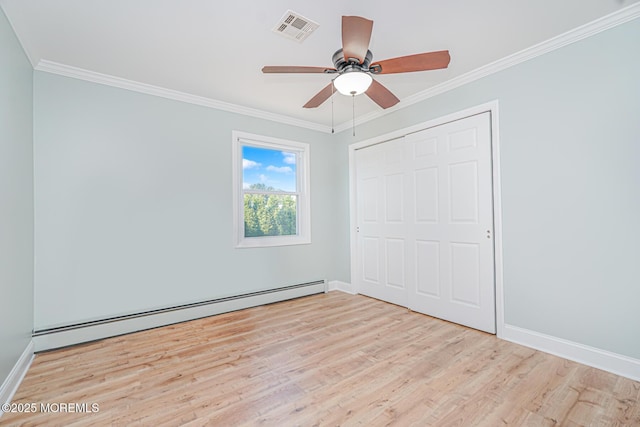 10 Inverell Dr, Toms River, NJ 08757 - unfurnished bedroom featuring wood finished floors, a baseboard heating unit, crown molding, baseboards, and a closet