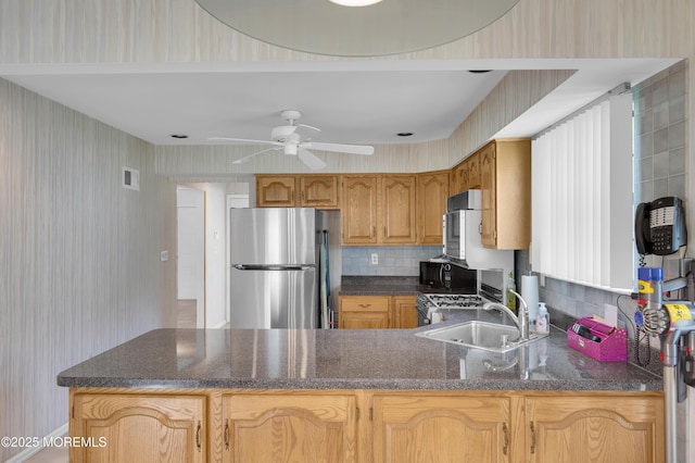 17 Suffolk Way, Marlboro, NJ 07746 - kitchen with freestanding refrigerator, wallpapered walls, black microwave, a peninsula, and a sink