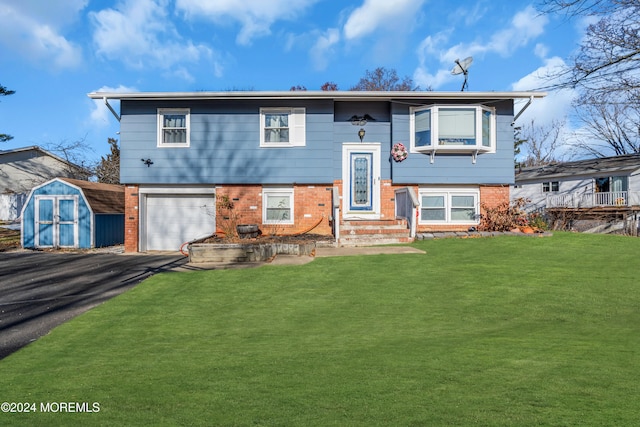 bi-level home with a storage unit, a front yard, and a garage