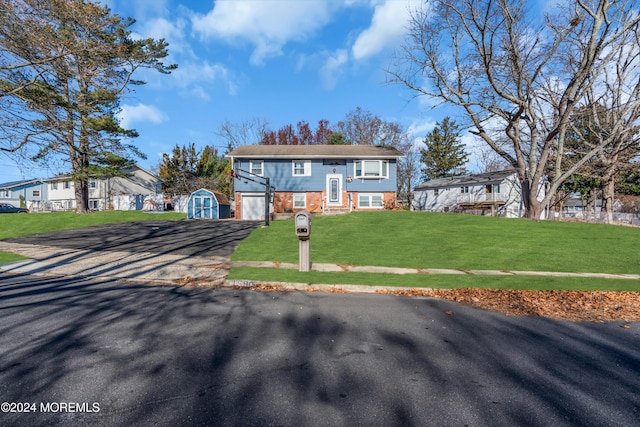 bi-level home with a shed and a front lawn