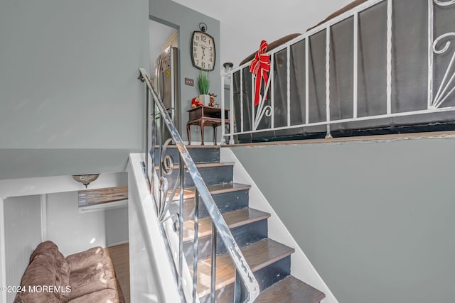 stairway featuring hardwood / wood-style flooring