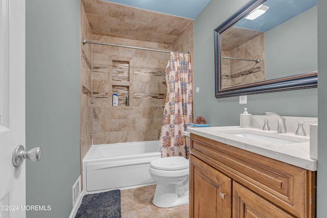 full bathroom featuring tile patterned floors, shower / tub combo with curtain, vanity, and toilet