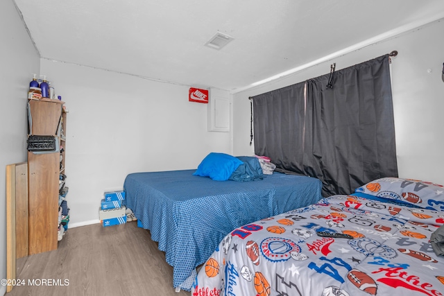 bedroom with hardwood / wood-style flooring