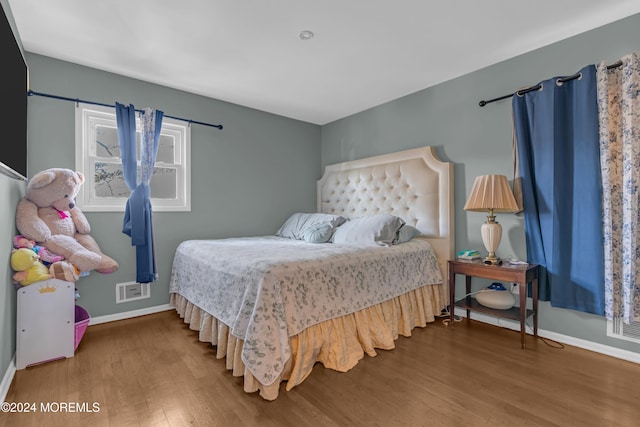 bedroom with hardwood / wood-style flooring