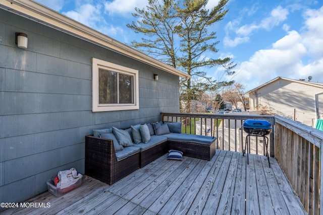 wooden deck with area for grilling and an outdoor hangout area