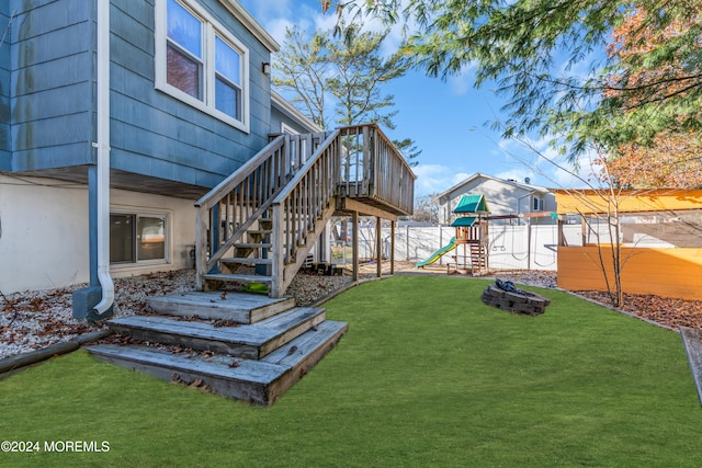 view of yard featuring a playground and a deck