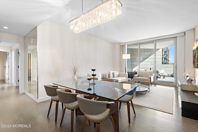 dining space featuring hardwood / wood-style flooring and an inviting chandelier