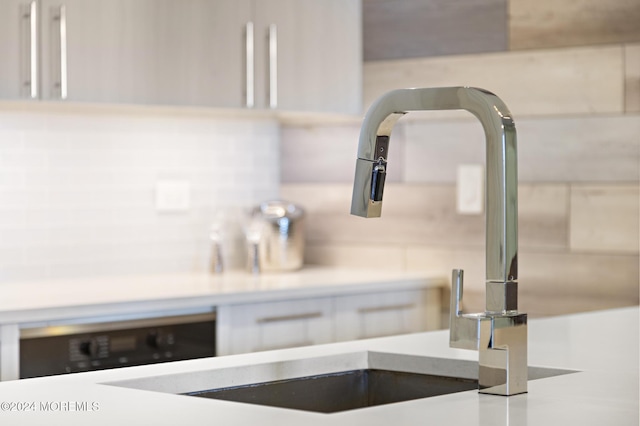 room details featuring white cabinets and sink