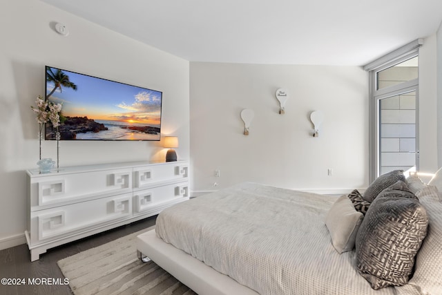 bedroom featuring dark hardwood / wood-style flooring and vaulted ceiling