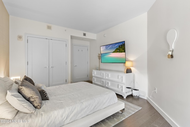 bedroom featuring a closet and dark hardwood / wood-style flooring