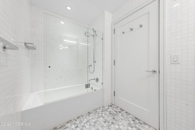 bathroom with tile patterned flooring and tiled shower / bath