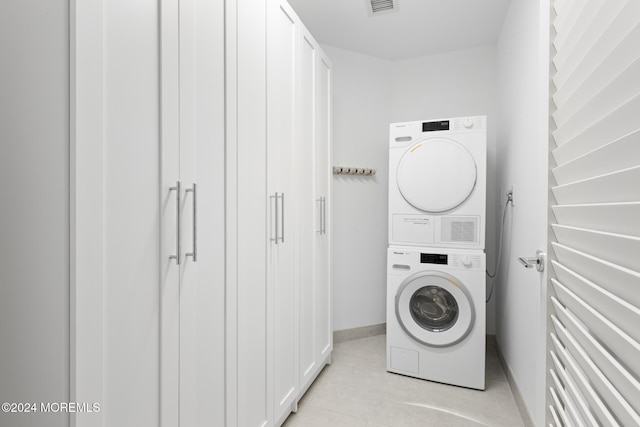 clothes washing area with stacked washer and dryer