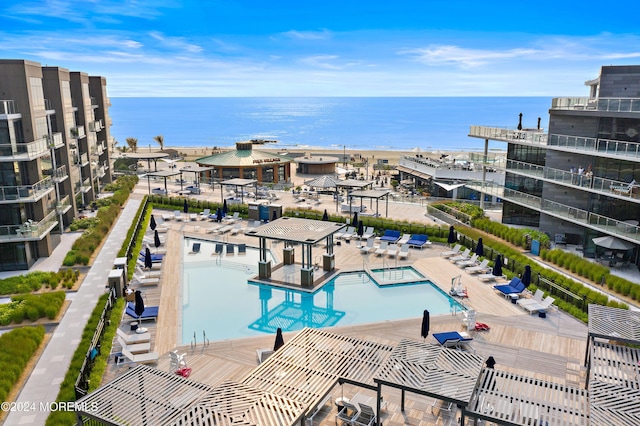 view of swimming pool featuring a water view