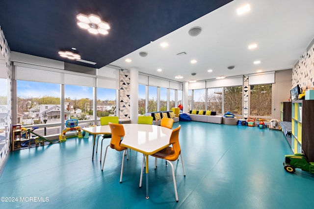 interior space featuring plenty of natural light and a wall of windows