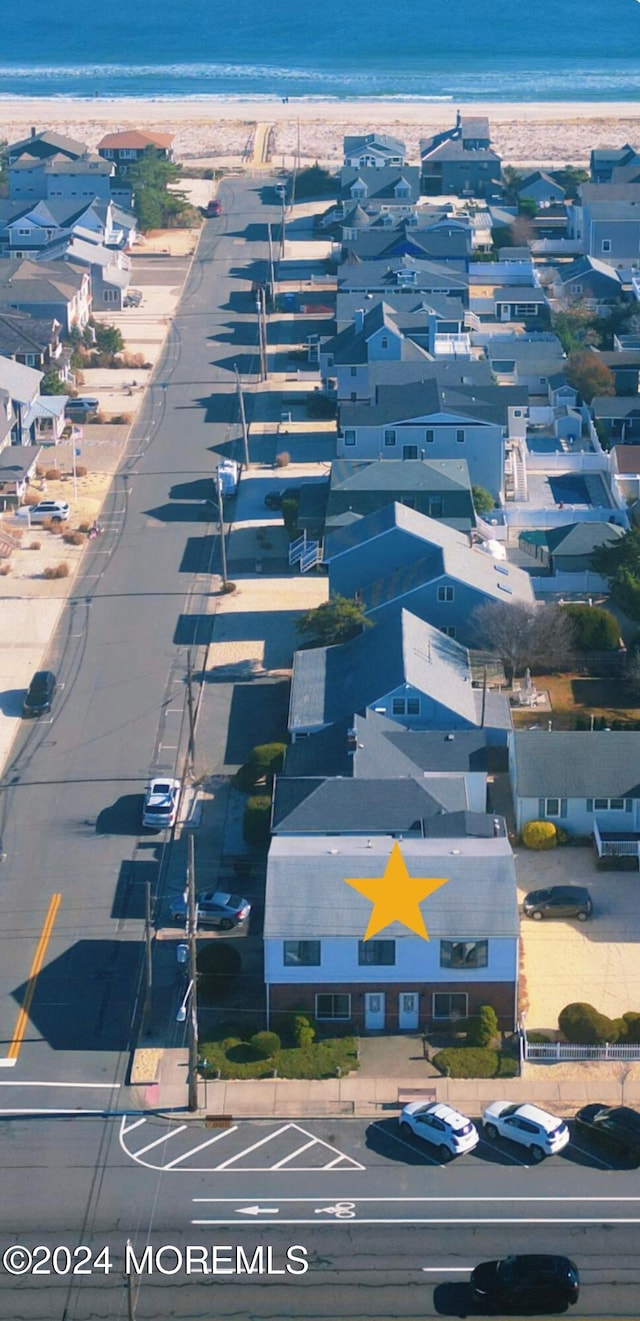 drone / aerial view with a water view and a view of the beach