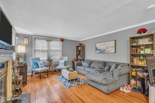 living room with ornamental molding and hardwood / wood-style flooring