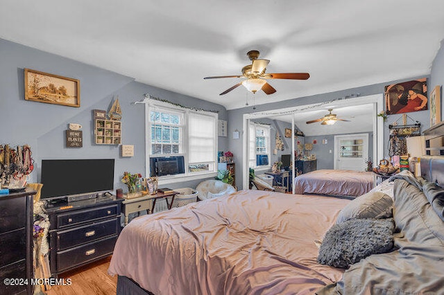 bedroom with light hardwood / wood-style floors and ceiling fan