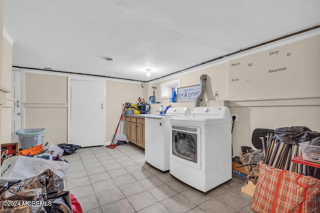 laundry room with cabinets, independent washer and dryer, and light tile patterned flooring