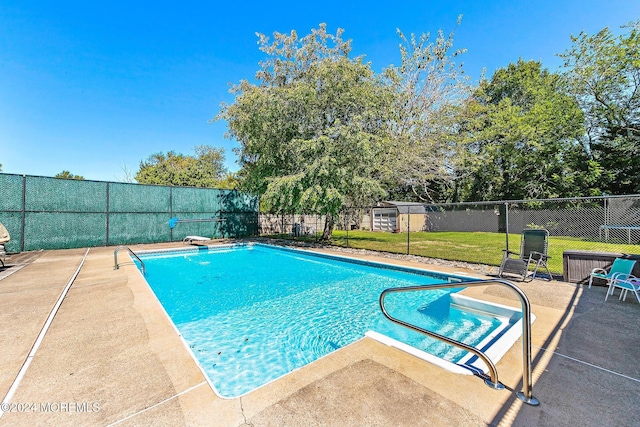 view of swimming pool with a patio area and a lawn