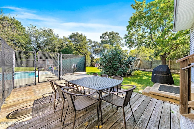 wooden terrace featuring a fenced in pool and a lawn