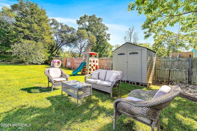 view of yard with a storage unit and a playground