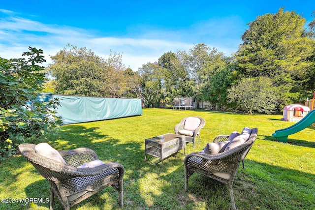 view of yard with a playground and a trampoline