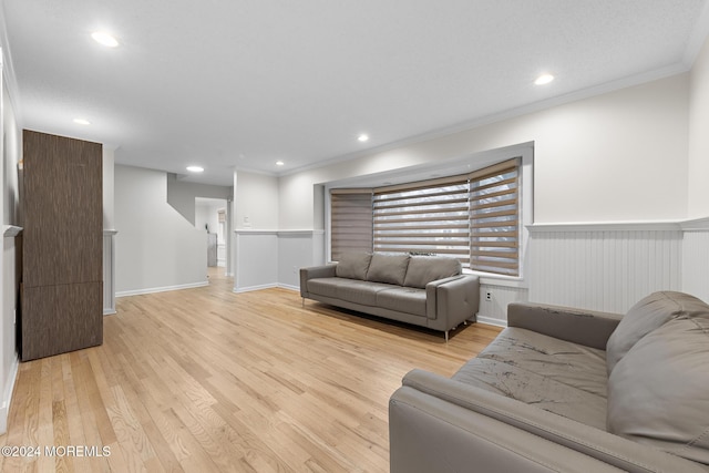 living room featuring light hardwood / wood-style floors and ornamental molding