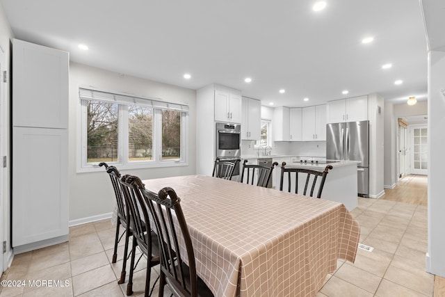 dining room with light tile patterned floors and sink