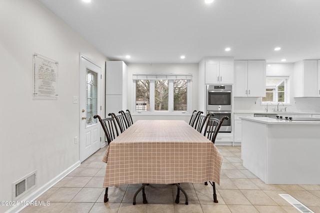 dining room featuring a healthy amount of sunlight and light tile patterned floors