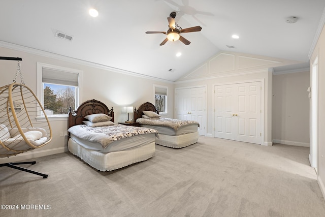 bedroom with ceiling fan, crown molding, vaulted ceiling, light carpet, and two closets