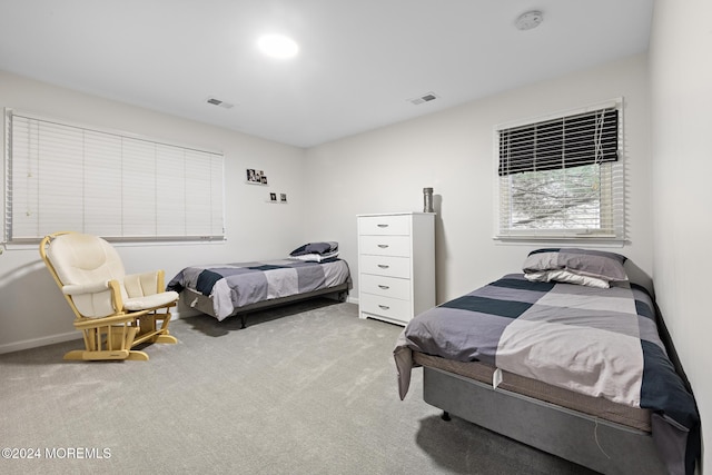 bedroom featuring light colored carpet