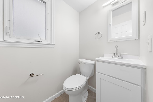 bathroom featuring tile patterned floors, vanity, and toilet