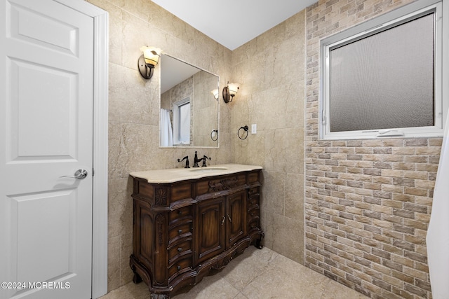 bathroom with vanity and tile walls