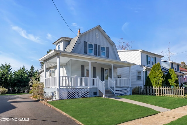 view of front of house featuring covered porch and a front yard