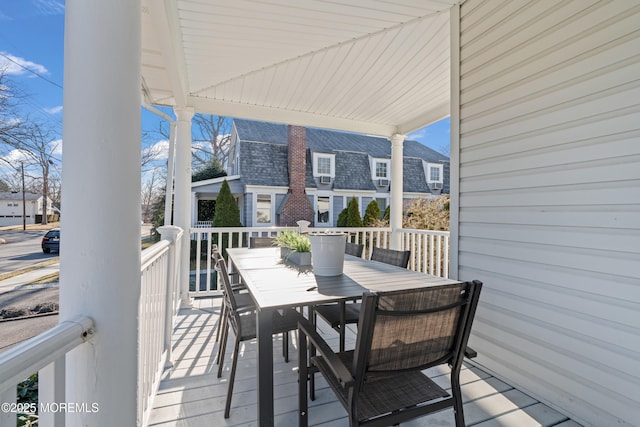 wooden terrace featuring outdoor dining area