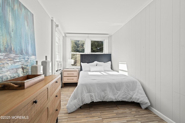 bedroom featuring baseboards and light wood-style floors