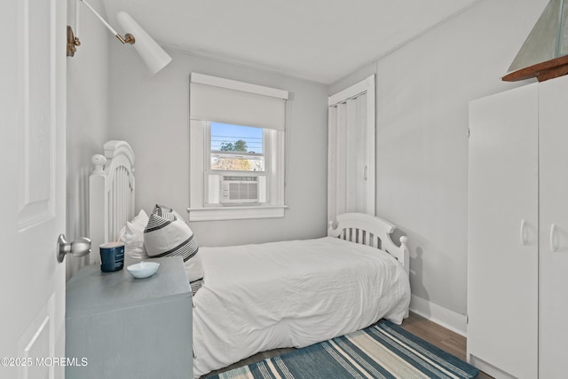 bedroom featuring baseboards and wood finished floors