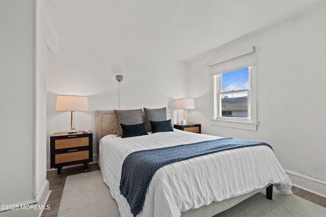 bedroom with baseboards and wood finished floors