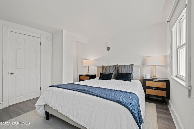 bedroom featuring baseboards and wood finished floors