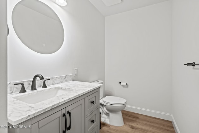 bathroom featuring hardwood / wood-style floors, vanity, and toilet