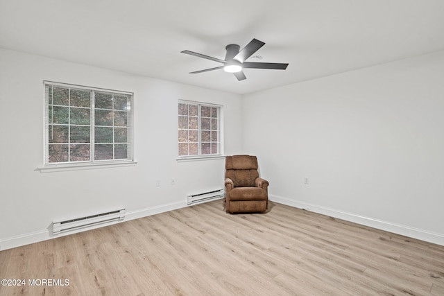 unfurnished room with baseboard heating, ceiling fan, and light wood-type flooring