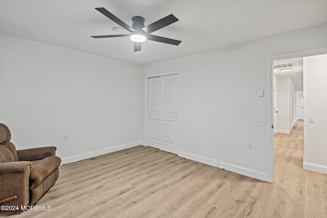 sitting room with ceiling fan and light hardwood / wood-style floors