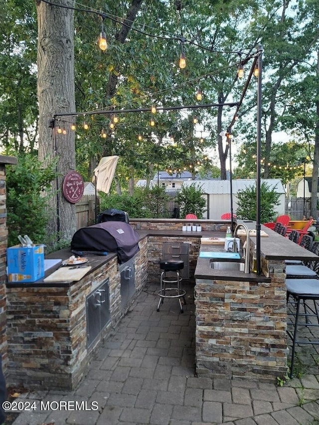 view of patio featuring area for grilling and an outdoor wet bar