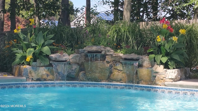 view of pool featuring pool water feature