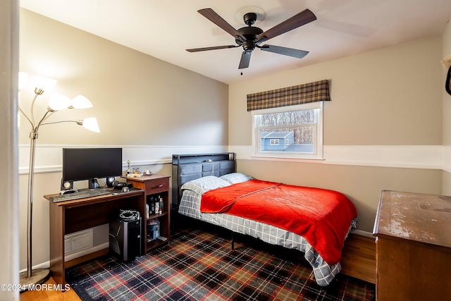 bedroom with ceiling fan and dark hardwood / wood-style floors