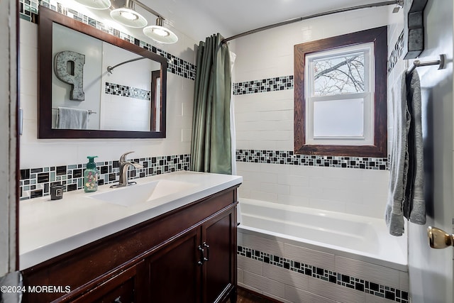 bathroom with backsplash, shower / bath combo with shower curtain, and vanity